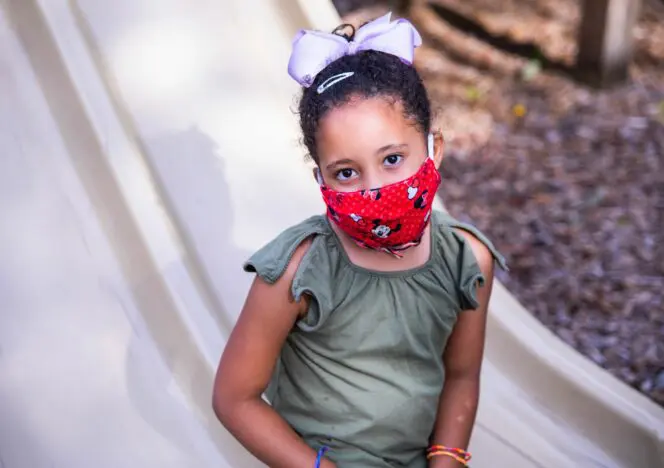 Children engaging in sensory activities using practical life materials.