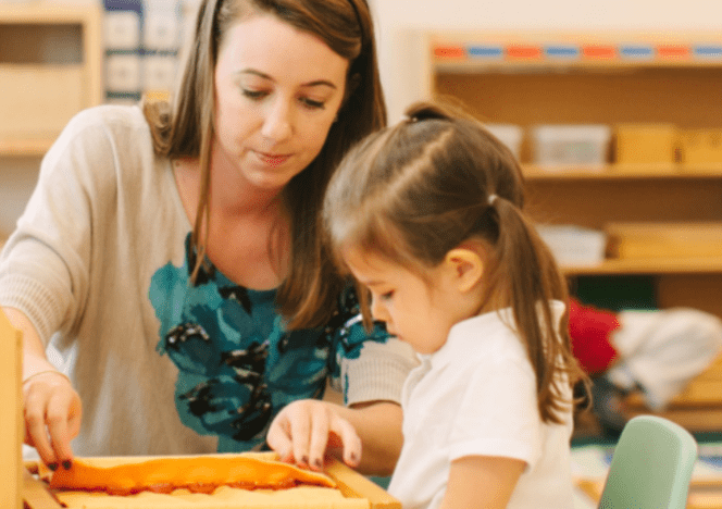 Student engaged in peaceful, individual work with a Montessori puzzle.