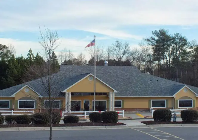 Children participating in nature-based learning activities in an outdoor Montessori environment.