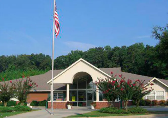 Mixed-age group working together on creative tasks in a Montessori classroom.