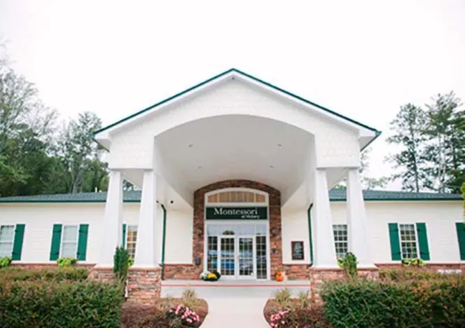 Children concentrating on self-chosen tasks, developing autonomy and focus.