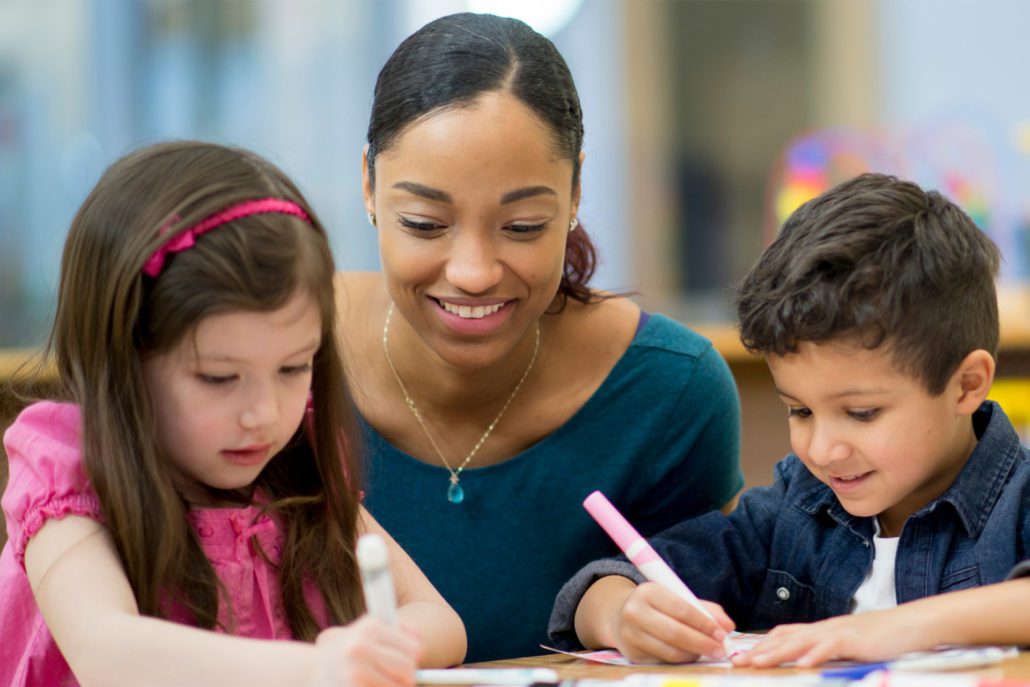 Children concentrating on self-chosen tasks, developing autonomy and focus.